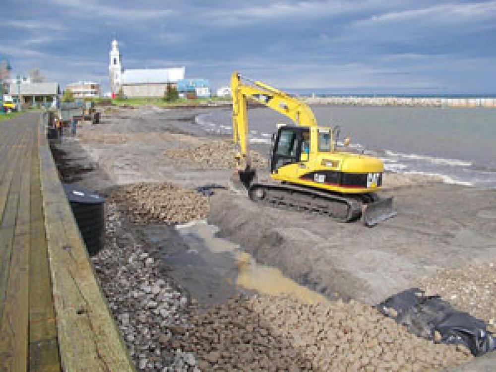 Mechanical shovel helps with beach nourishment work