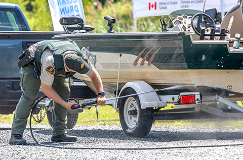 A Fishery Officer cleaning a boat