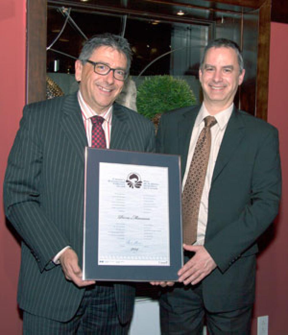 Pierre Manseau (left) receives one of the five Canada National Recreational Fisheries Awards from Patrick Vincent, Regional Director, Fisheries Management, Fisheries and Oceans Canada.